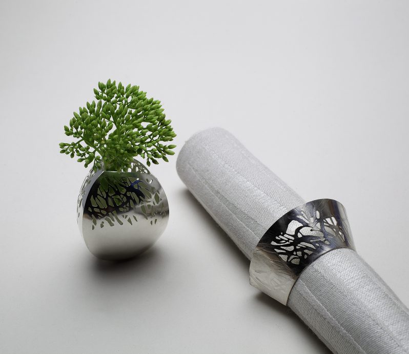 Napkin ring and vase with open reed collar. Silver. Photography by Jaap Oldenkamp.